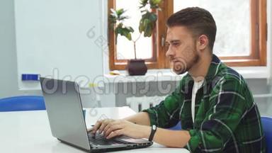 一个年轻人坐在教育机构的电脑前